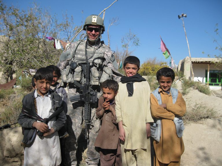 Sgt. Pike with local children in Afghanistan